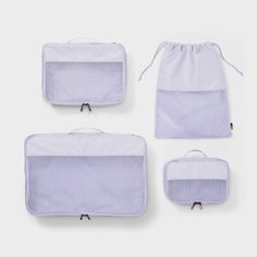 three pieces of purple and white mesh bags with zippers on each side, one in the