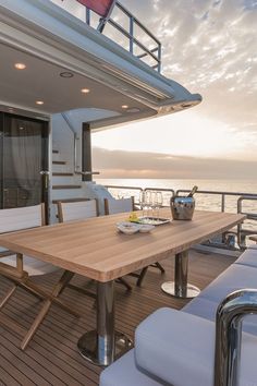 a table and chairs on the deck of a boat