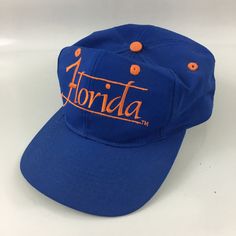 Item is in good vintage condition with no damage or rips. It has sweat stains and some creases on the hat. Blue Retro Snapback Hat For Outdoor, Retro Blue Hats With Embroidered Logo, Retro Blue Snapback Hat For Sports Events, Vintage Blue Snapback Hat For Streetwear, Vintage Orange Snapback Hat, Orange Hats, Polo Sport Ralph Lauren, Sweat Stains, Hats Snapback