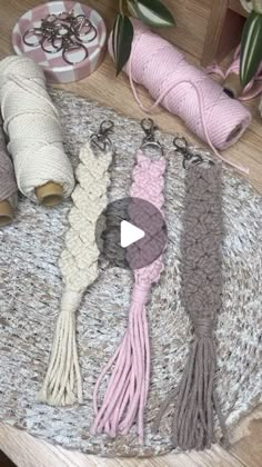 yarns and crochet are laid out on the floor for making scarves