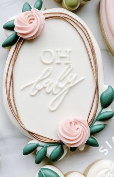 a birthday cake decorated with pink roses and green leaves