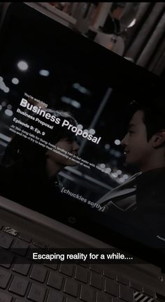 a computer screen with the words business proposal on it and an image of a man looking at his cell phone