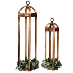 two wooden lanterns with plants in them