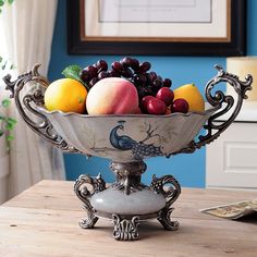 a bowl filled with fruit sitting on top of a wooden table