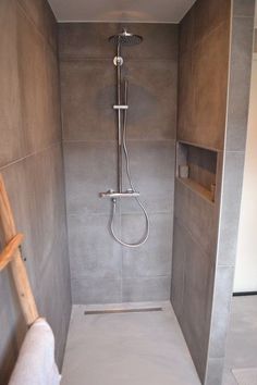 a walk in shower sitting inside of a bathroom next to a wall mounted faucet