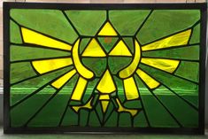 a stained glass window with an image of the legend of zelda emblem on it