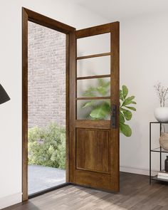 an open wooden door in a living room next to a lamp and table with a potted plant on it