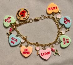 a bracelet with charms that say i love you, me, hug me and be mine