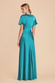 a woman in a teal dress with short sleeves and pleaed skirt, back view