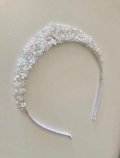 A handmade tiara made with lots of tiny sparkling beads, crystals and freshwater pearls. Band can be covered in different ribbon such as brown or blonde/gold to match your hair.  This hairpiece is approximately an inch high at the centre point  This design has been lovingly made in the UK SHIPPING AND PACKAGING- All Ivy and Pearl hairpieces come packaged in a beautiful gift box. I offer refunds and exchanges. Please see 'Shop Policies' section for further information and exceptions. All hairpieces are especially handmade for each customer. You will receive an email from etsy when I have posted your order. UK orders are sent by second class class mail and should arrive within two working days of being posted. They will need to be signed for Orders to Europe take around three to five working Headband Wedding Hair, Crystal Bridal Headband, Bridal Hair Bands, Handmade Tiaras, Bridal Hair Combs Pearl, Silver Tiara, Headband Wedding, Silver Headband, Crystal Headpiece