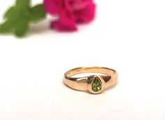 Beautiful and unique solid gold ring signet ring set with pear-shaped peridot, alternative engagement or wedding ring. This wide 14K yellow gold ring is set with a pear-shaped light green peridot. The ring's wide design and the color of the peridot give this ring a certain air of majestic and quiet confidence.This ring is comfortable and noticeable and will be great for everyday use, as for a special occasion. It can also be a modern engagement ring.This ring will be a perfect gift for a strong Yellow Gold Teardrop May Birthstone Ring, Yellow Gold Teardrop Ring For May Birthstone, Gold Teardrop Emerald Promise Ring, Pear Shaped Bezel Setting Wedding Rings, Pear-shaped Bezel Set Wedding Ring, Pear-shaped Bezel Setting Ring As Gift, Pear Shaped Ring With Bezel Setting As Gift, Pear-shaped Rings With Tension Setting For Gift, Pear-shaped Ring With Bezel Setting For Gift