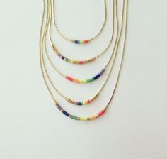 "Rainbow necklace beaded, Gay Pride necklace, Equality flag. This listing for one necklace. All version are available in gold tone or silver tone. DETAILS - Japanese color glass seed beads - Dainty but strong chain - Necklace Version (Rainbow). Available 7 versions with gold tone chain&spacers and 7 with silver tone chain&spacers. You can also create your own version :) - Necklace Length. Choose in the drop down menu (1 inch = 2.5 cm) - Two stoppers preventing glass beads from sliding on Pride Necklace, Flag Pride, Lgbt Flag, Celestial Necklace, Rainbow Jewelry, Rainbow Necklace, Wedding Jewellery Necklace, Pride Flag, Glass Seed Beads