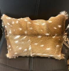 an animal print pillow sitting on top of a chair