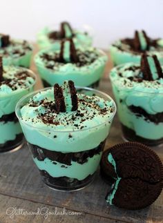 mint green desserts with oreo cookies on the side are ready to be eaten