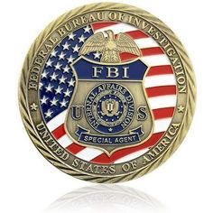 a police badge with an american flag on the front and bottom, is shown in gold