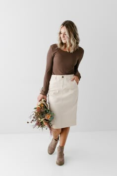 Elevate your denim collection with the 'Adrian' Denim Skirt! This midi skirt is made from cotton with a hint of stretch for comfortable all day wear. The flattering high waist is accented by a back double dart detail for a feminine fit at the waist. Featuring deep pockets to stash your phone or keys on the go and wide belt loops for a little flair. This denim midi skirt is perfect for tucking a statement tee or cozy sweater. This style is a perfect mix of classic and relaxed for work wear or the Petite Skirt Outfit, Jean Midi Skirt Outfits, Jean Skirt Outfits Fall, Jean Midi Skirt, Cream Pencil Skirt, Feminine Outfits, Outfit Options, 27 Dresses, Modesty Outfits