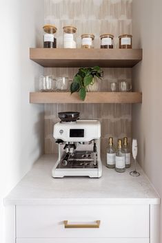 a white coffee maker sitting on top of a counter