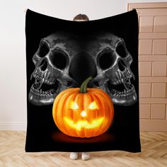 a skull and a pumpkin on a black background