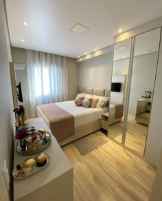 a bed room with a neatly made bed and a tray of food on the counter