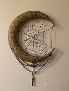 a woven dream catcher hanging on the wall