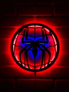 a red and blue spider logo on a brick wall