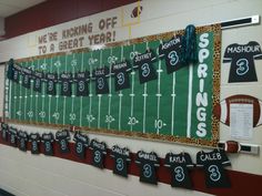 a football themed bulletin board in the hallway