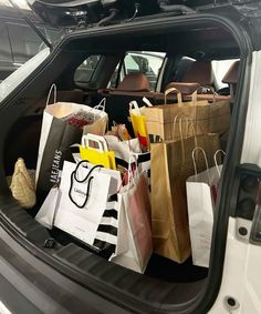 the trunk of a car filled with shopping bags