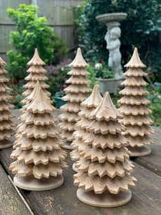 small wooden trees are lined up on a table