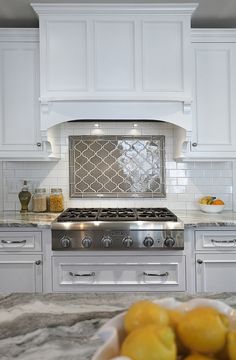 a white kitchen with marble counter tops and stainless steel stove top oven, which is on sale for $ 350