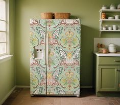 a green and orange patterned refrigerator in a kitchen