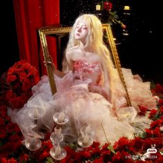 a woman sitting in front of a mirror surrounded by roses