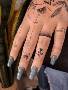 a woman's hand with tattoos on it