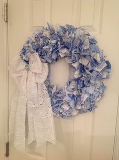 a blue and white wreath hanging on the front door