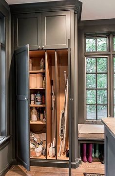 an open cabinet in the middle of a kitchen