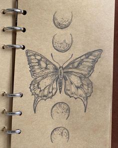 a drawing of a butterfly and phases of the moon on a piece of brown paper