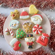 decorated cookies on a plate with tinsel in the background