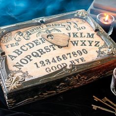 a box with some writing on it next to candles and other items that include scissors