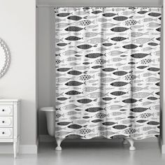 a shower curtain with black and white fish on it