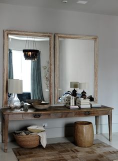 a large mirror sitting on top of a wooden table