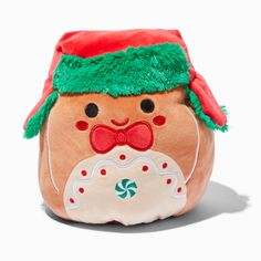 a small stuffed toy with a red hat and green scarf on it's head