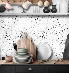 black and white wallpaper in a kitchen with plates, utensils and pots