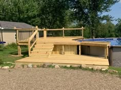 an above ground pool with steps leading up to it and a deck on the other side