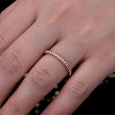 a woman's hand with a diamond ring on her left hand and the middle finger