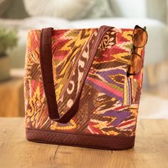 Burgundy Tote Bag with Multicolored Patchwork Ikat Pattern - Exuberance | NOVICA Square Multicolor Bucket Bag For Travel, Multicolor Travel Bucket Bag With Top Handle, Multicolor Square Hobo Bag For Travel, Multicolor Square Bucket Bag For Travel, Rectangular Reversible Shoulder Bag For Travel, Multicolor Travel Bucket Bag With Top Carry Handle, Reversible Brown Shoulder Bag For Travel, Multicolor Hobo Bag With Top Carry Handle For Everyday, Multicolor Square Shoulder Bag For Daily Use