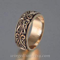 a wedding ring with intricate designs on it