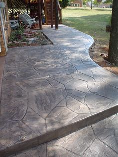 an outdoor patio with stone steps and trees