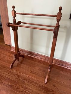 there is a wooden rail in the middle of a room with wood floors and hard wood flooring