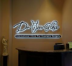 the logo for dr your glass international clinic for cosmetic surgery is lit up against a wall