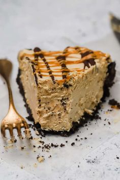 a piece of cheesecake with chocolate and caramel drizzled on top