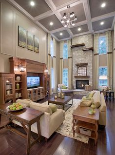 a living room filled with furniture and a fire place next to a tv mounted on the wall